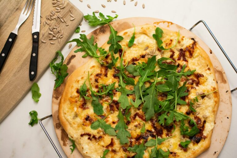 Homemade cheese pizza with arugula.